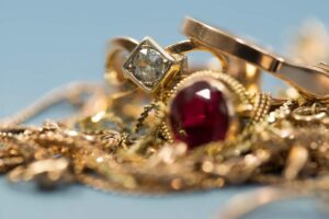 A variety of fine jewelry pieces neatly organized in a lined, multi-compartment jewelry box.